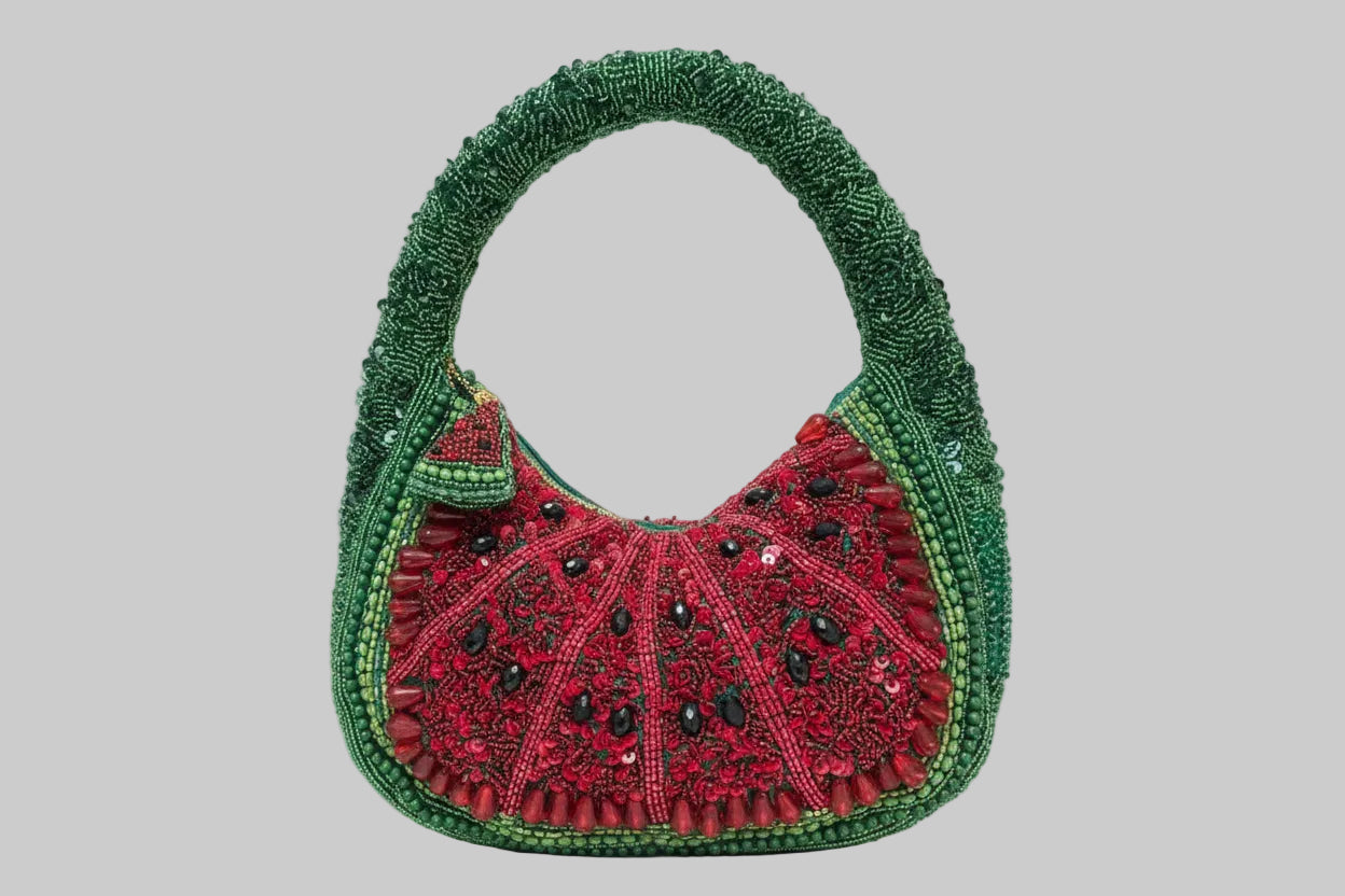 Decorative handbag with watermelon green and red design on a white background