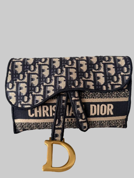 Christian Dior handbag with logo pattern on a gray background