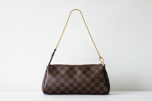 Brown checkered handbag with a chain strap on a light gray background