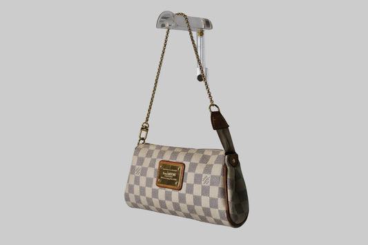 Checkered handbag with a brand logo on a gray background