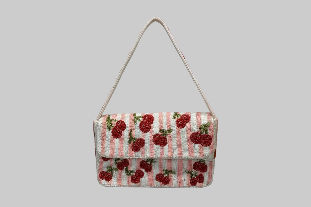 Small handbag with cherry pattern on a white background