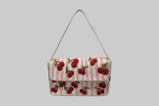 Small handbag with cherry pattern on a white background