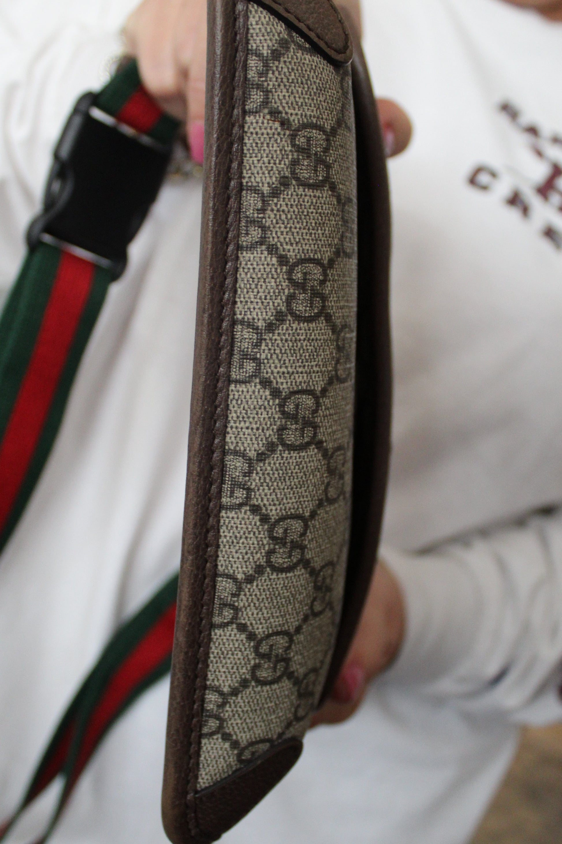 Close-up of a Gucci bag strap with monogram pattern