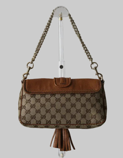 Brown patterned handbag with chain strap on a gray background