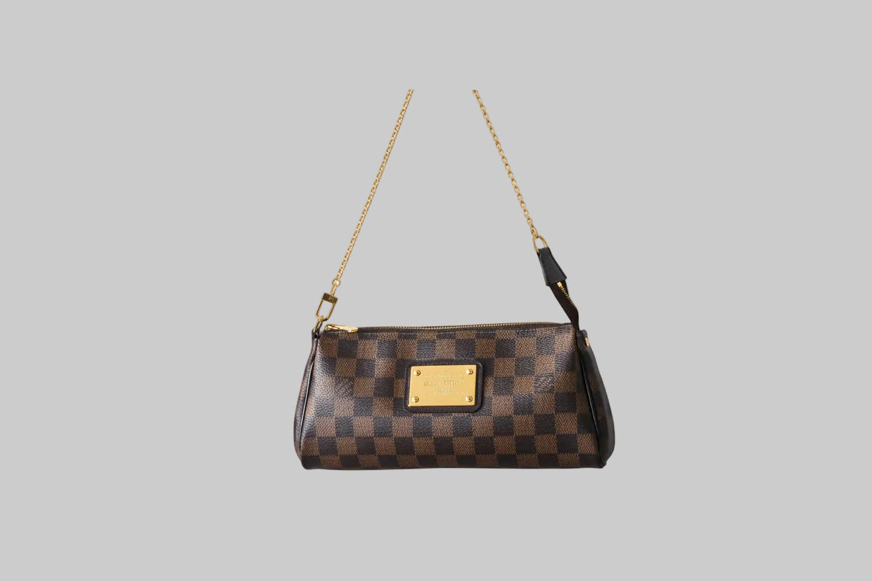 Designer handbag on a stand against a gray background