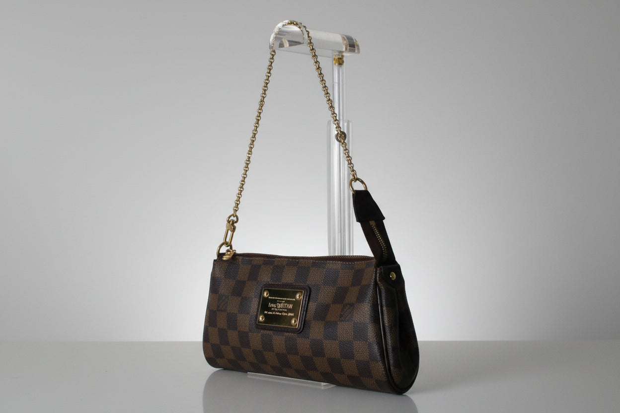 Designer handbag with checkered pattern on a gray background