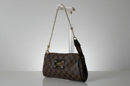 Designer handbag with checkered pattern on a gray background