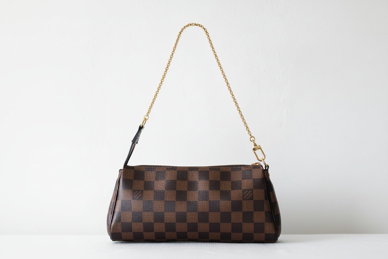 Brown checkered handbag with a chain strap on a light gray background