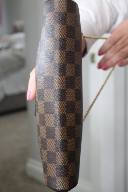 Checkered handbag held by a person with a blurred background