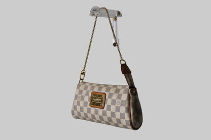 Checkered handbag with a brand logo on a gray background