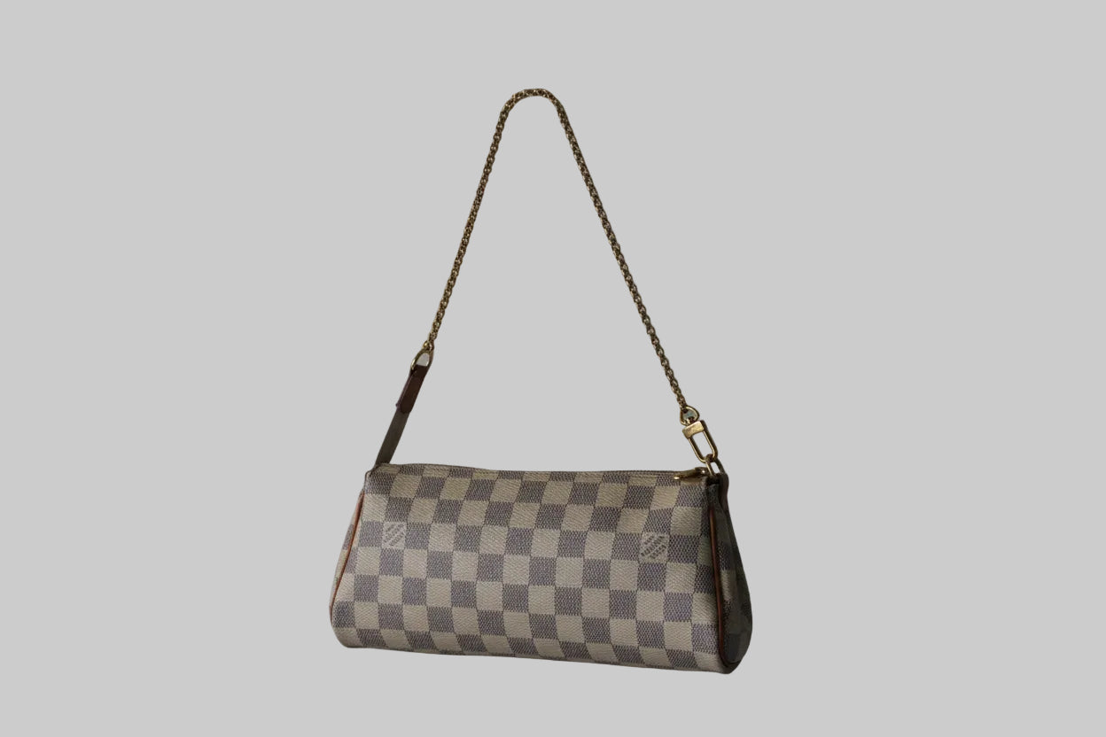 Checkered handbag with a strap on a light gray background