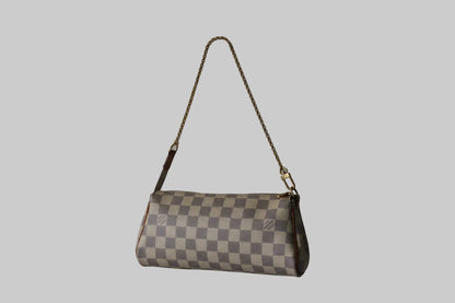 Checkered handbag with a strap on a light gray background