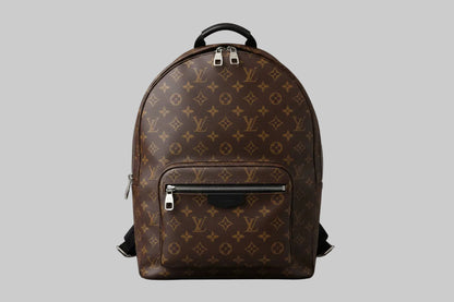 Brown backpack with monogram pattern on a gray background