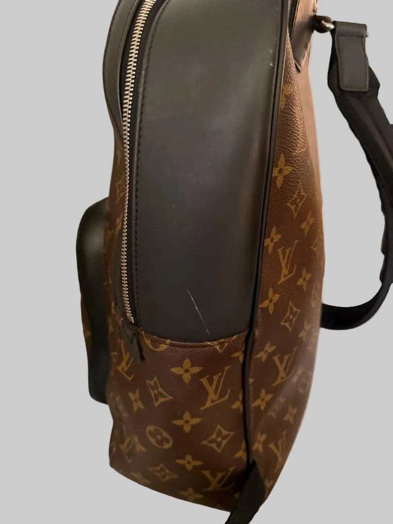 Brown leather bag with monogram pattern on a light gray background
