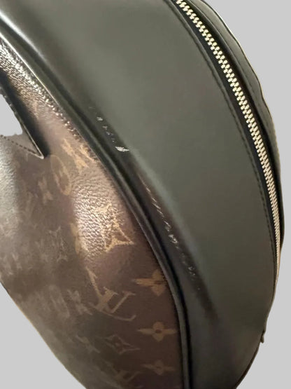 Louis Vuitton monogram bag with a visible logo on a neutral background