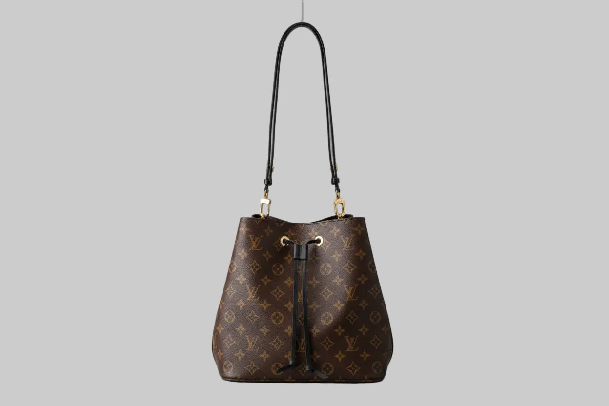 Designer handbag with monogram pattern on a gray background