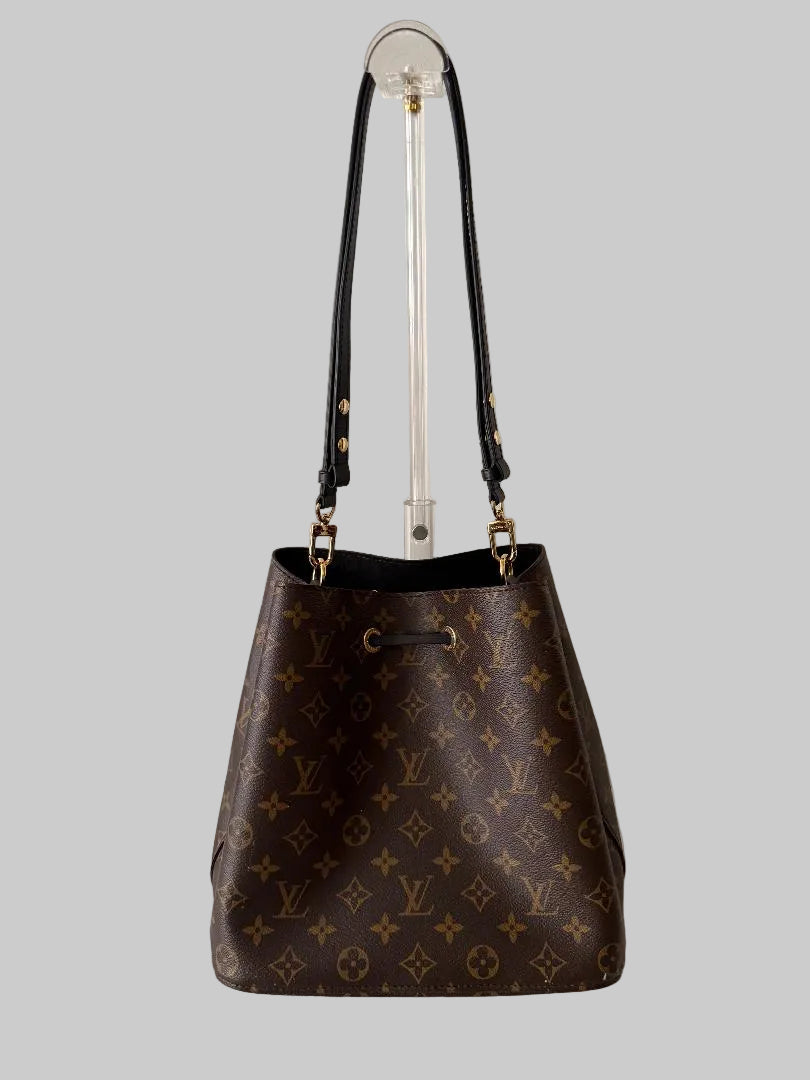 Brown monogram handbag on a gray background