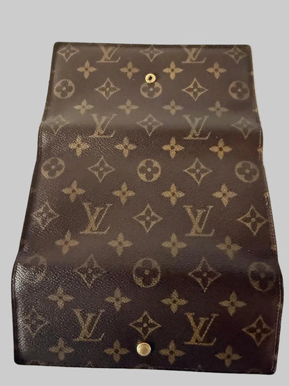 Louis Vuitton monogram wallet with coin purse on a gray background