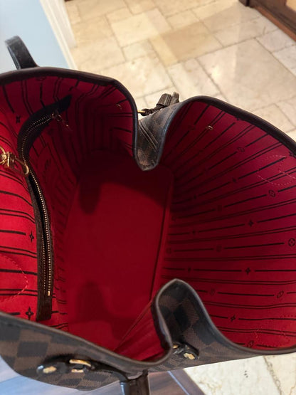 Close-up of a red and black patterned bag with gold accents.