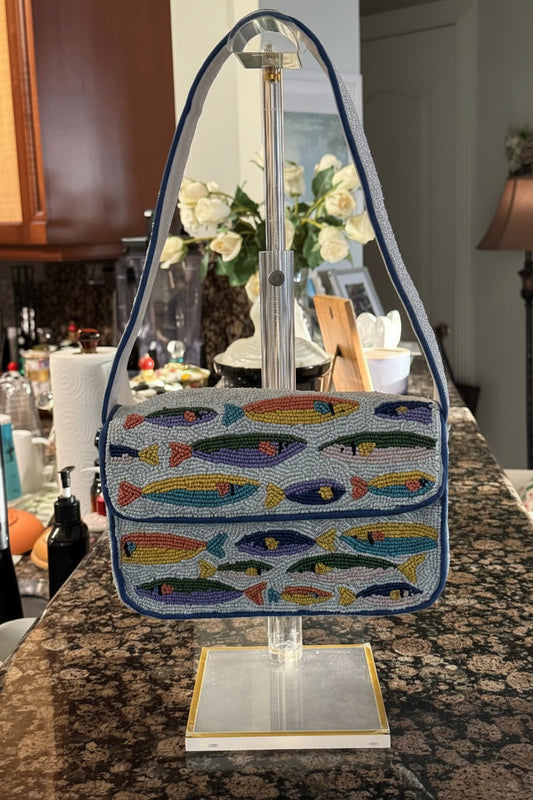 Beaded Handbag with fish pattern on a stand in a kitchen setting