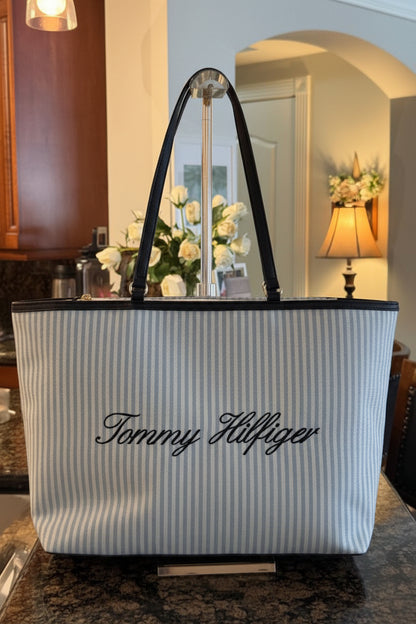 Striped tote bag with 'Tommy Hilfiger' logo in a room setting
