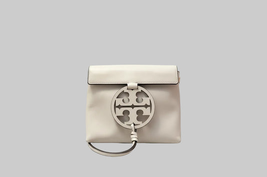 Cream/White handbag with a prominent Tory Burch logo on a light g background