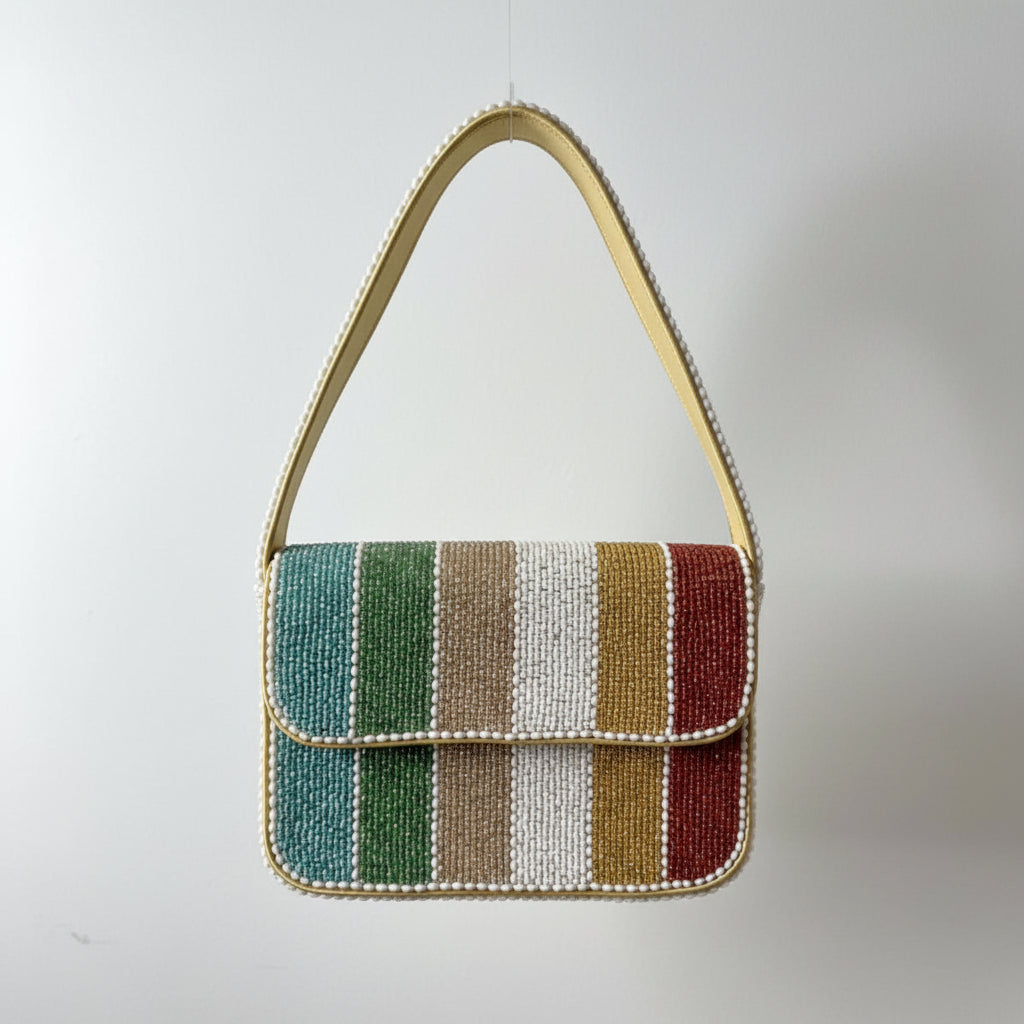A small beaded shoulder bag with a striped pattern in green, blue, beige, brown, and red, featuring a gold-tone handle and trim.