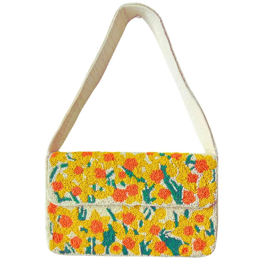 A small shoulder bag with a vibrant yellow floral pattern and a cream-colored strap, shown against a plain white background.