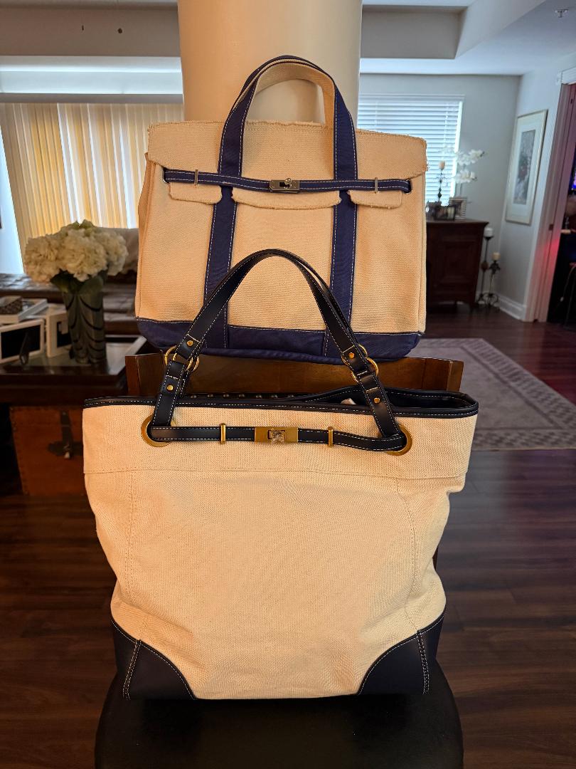 Two beige and navy handbags on a mannequin in a room with furniture and decor.